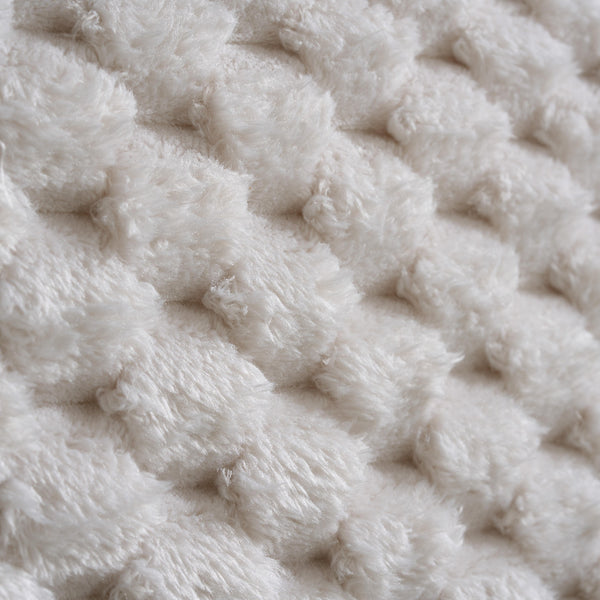 Close-up of a textured beige fabric surface