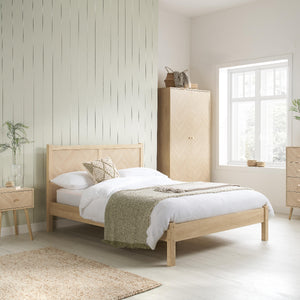 Bedroom with wooden bed and wardrobe in a bright room