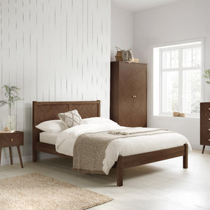 Wooden bed with white bedding in a bright bedroom setting