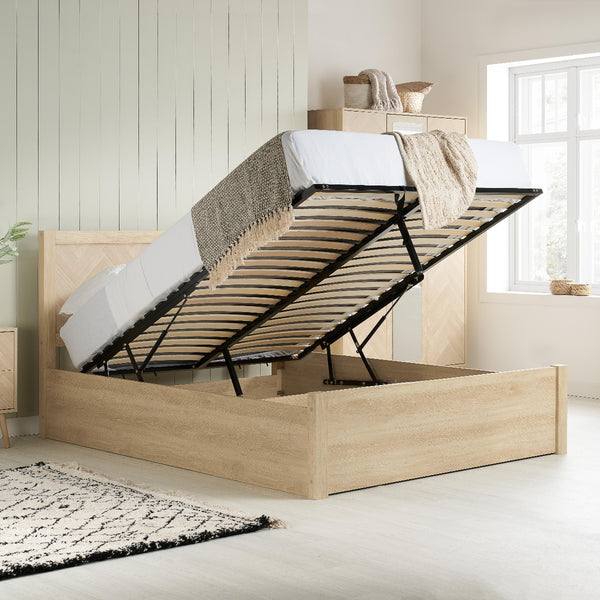 Wooden bed frame with storage compartment in a bright bedroom.
