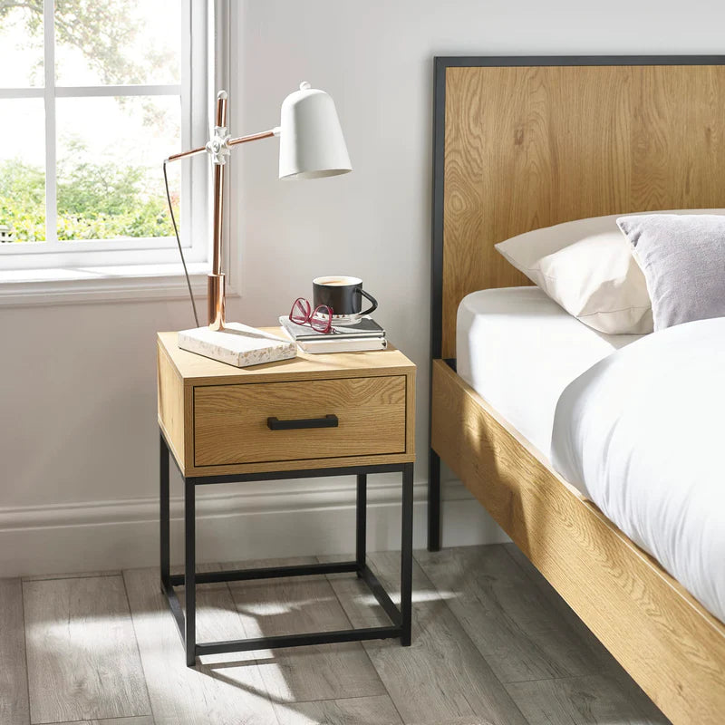 Wooden side table with a drawer and black metal frame on a white background