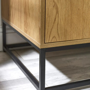 Wooden cabinet with black metal legs on a light wooden floor