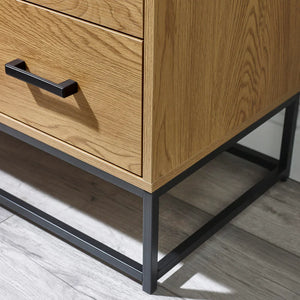 Wooden cabinet with black metal legs and handle on a wooden floor.