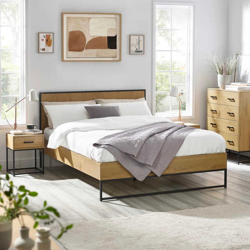 Wooden bed frame with metal legs on a white background