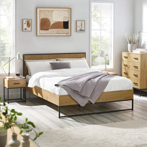 Modern bedroom with wooden bed, side tables, and abstract art on the wall.