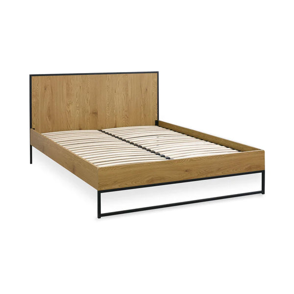 Wooden bed frame with metal legs on a white background