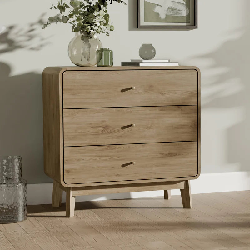Wooden dresser with three drawers on a white background