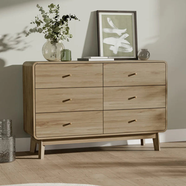 Wooden dresser with decorative items on a wooden floor