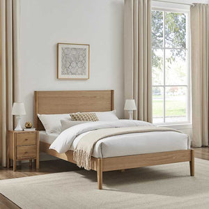 Wooden bed in a bedroom with white bedding and side tables.