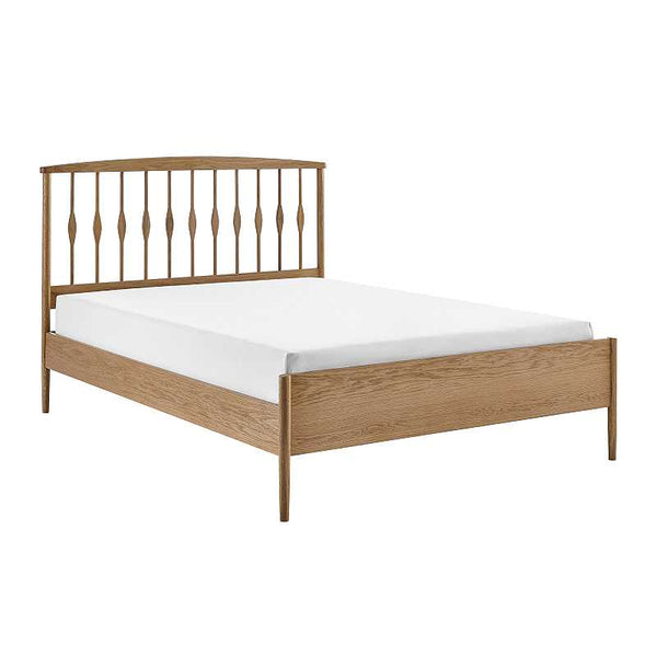 Wooden bed frame with white mattress on a white background