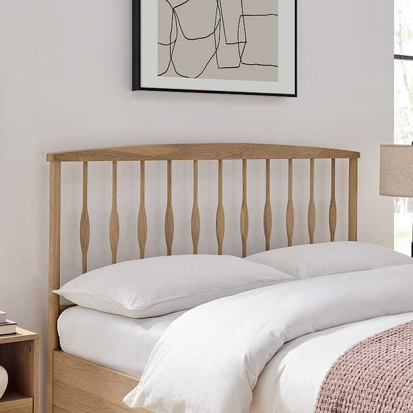 Wooden bed with white bedding in a bedroom setting
