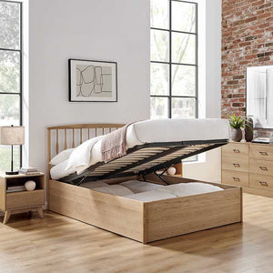 Wooden bed with storage drawers in a modern bedroom setting.