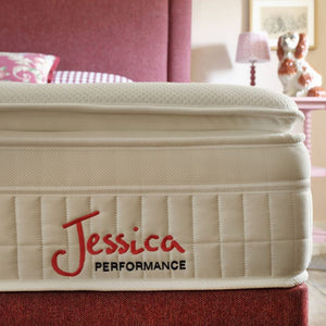 Beige mattress with 'Jessica Performance' branding in a bedroom setting.