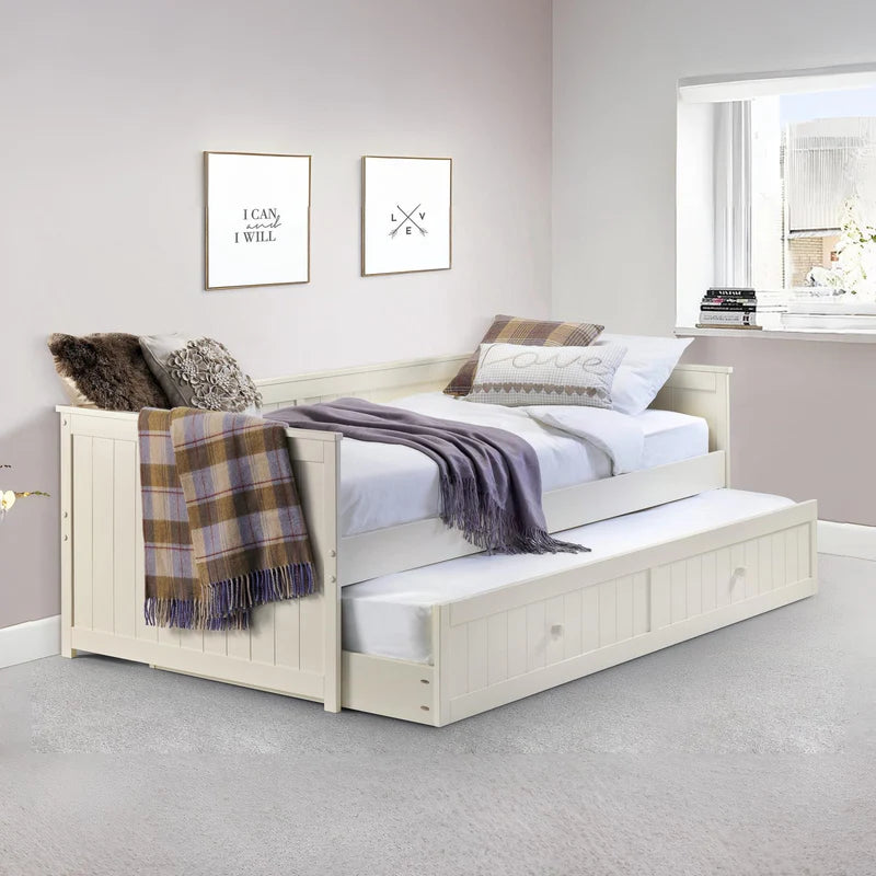 Wooden bed with trundle and blankets on a white background