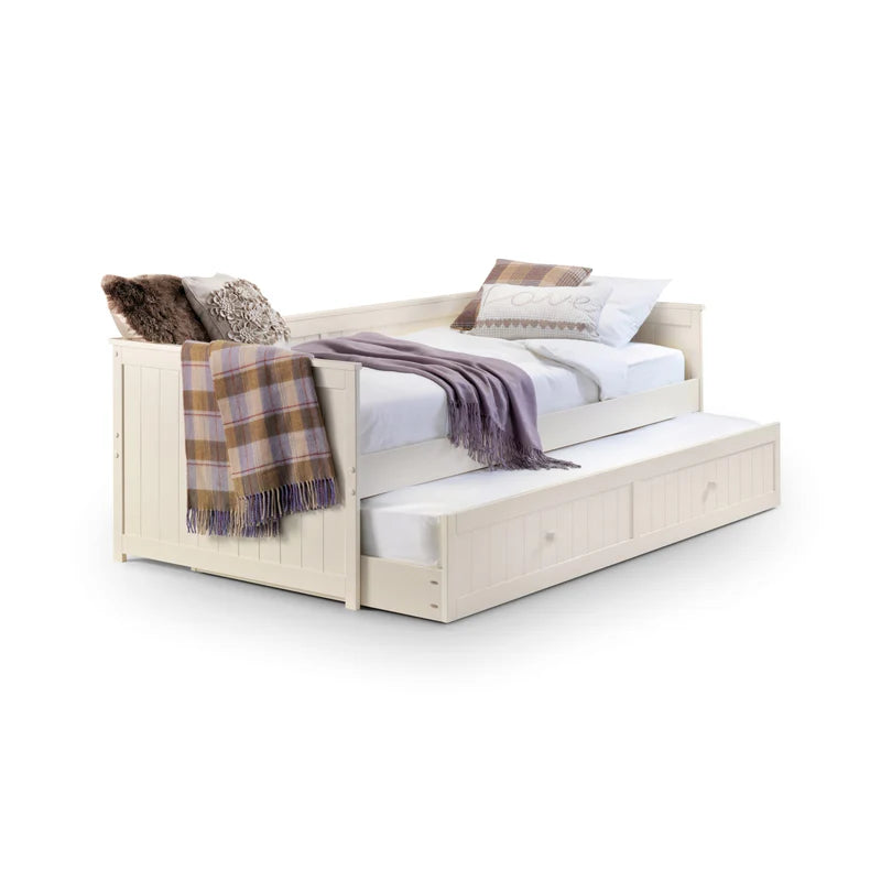 Wooden bed with trundle and blankets on a white background