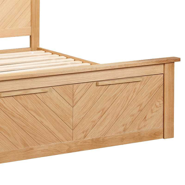Wooden bed frame with a chevron pattern on a white background