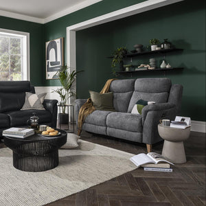 Living room with dark green walls, gray sofa, and black coffee table.