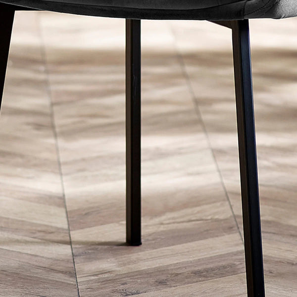 Close-up of a chair leg on a wooden floor