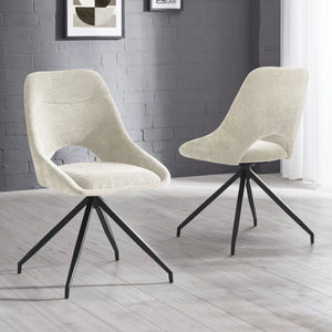 Two beige chairs with black metal legs on a light wooden floor against a gray brick wall.