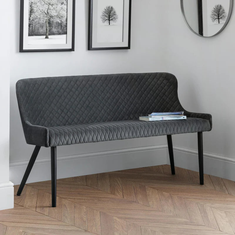 Black quilted sofa on a white background