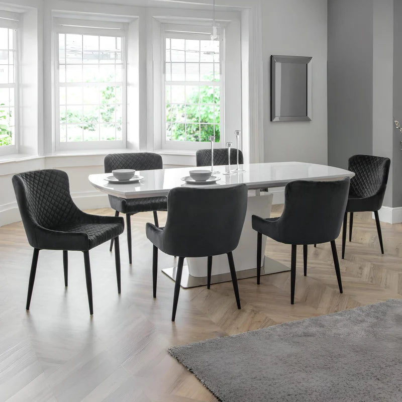 Two gray quilted chairs with black legs on a white background