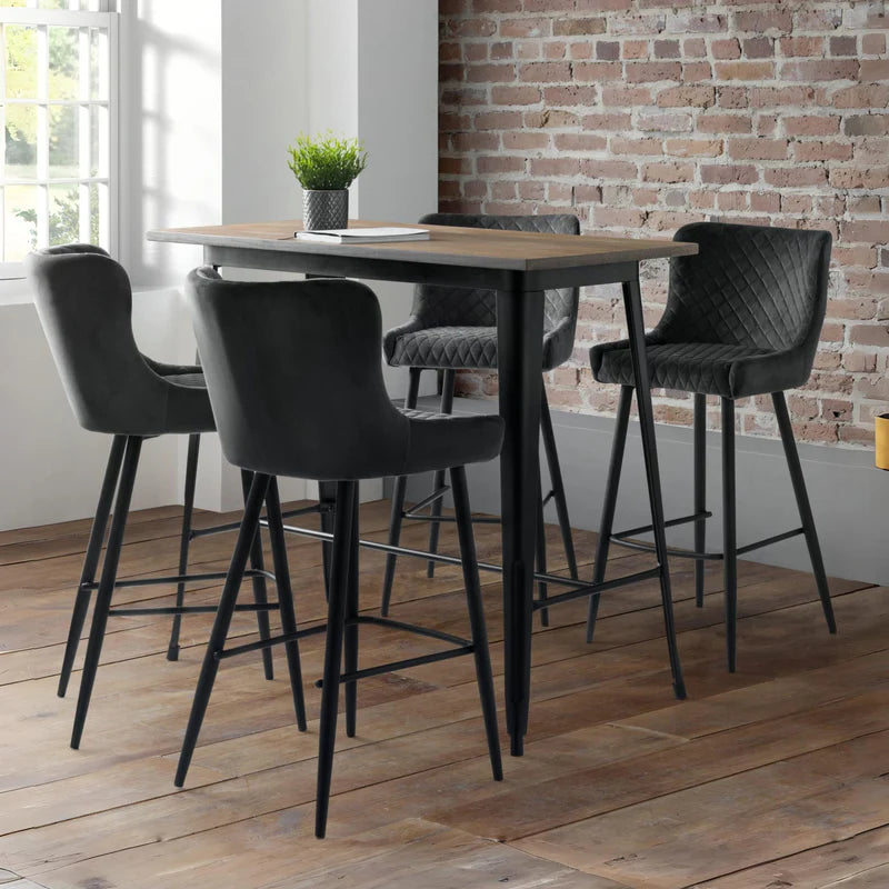 Gray quilted bar stool with black legs on a white background