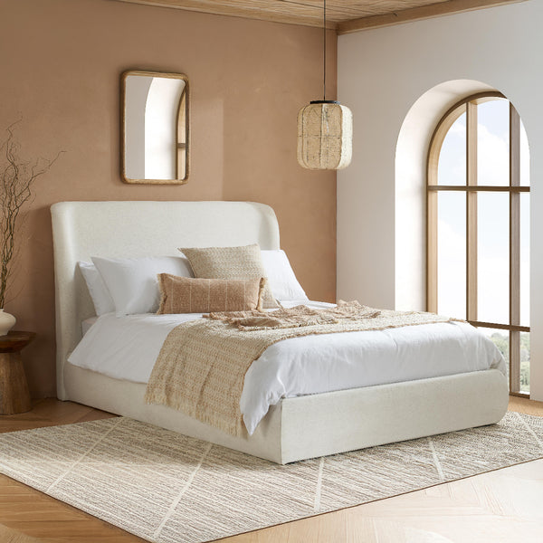 Modern bedroom with a white bed, beige rug, and wooden floor.