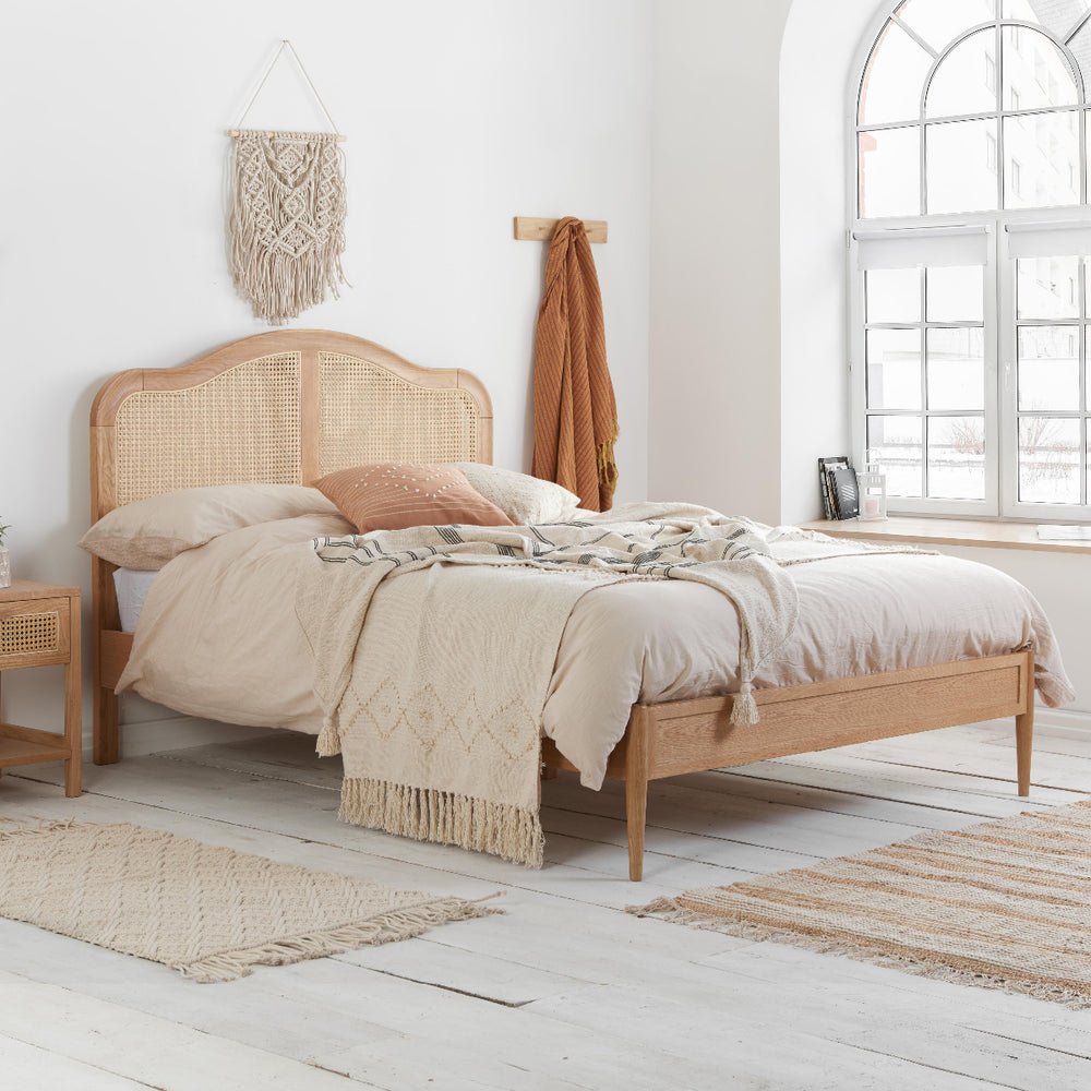 Wooden bed frame with mattress on a white background