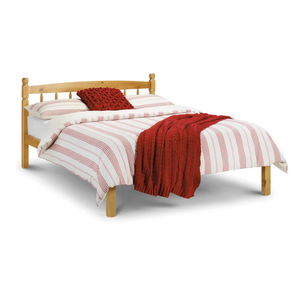 Wooden bed with red and white striped bedding on a white background