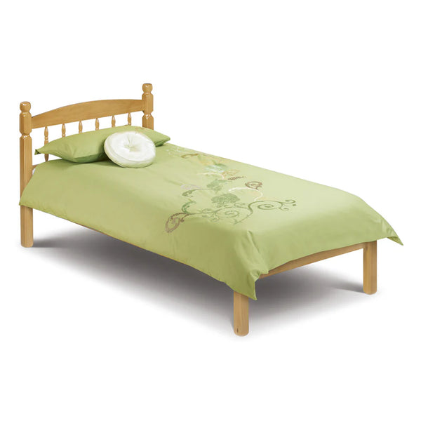 Single bed with green bedding and wooden headboard on a white background