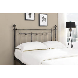 Metal headboard with white bedding in a bedroom setting