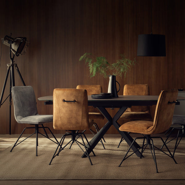 Dining room with a dark wooden table and chairs against a wooden wall.