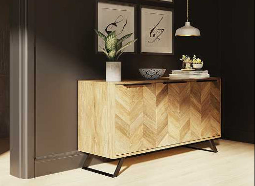 Wooden sideboard against a dark wall with decorative items