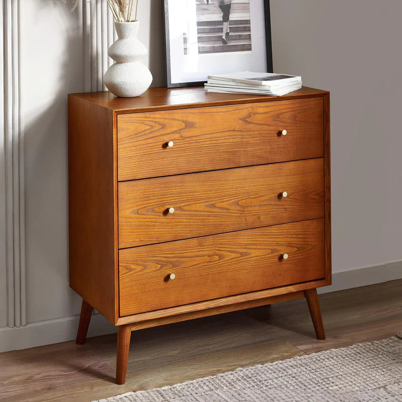Wooden dresser with three drawers on a white background