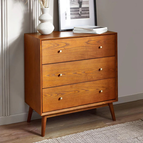 Wooden dresser with three drawers in a room setting