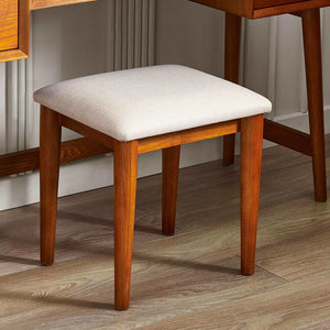 Wooden stool with a white cushion on a wooden floor