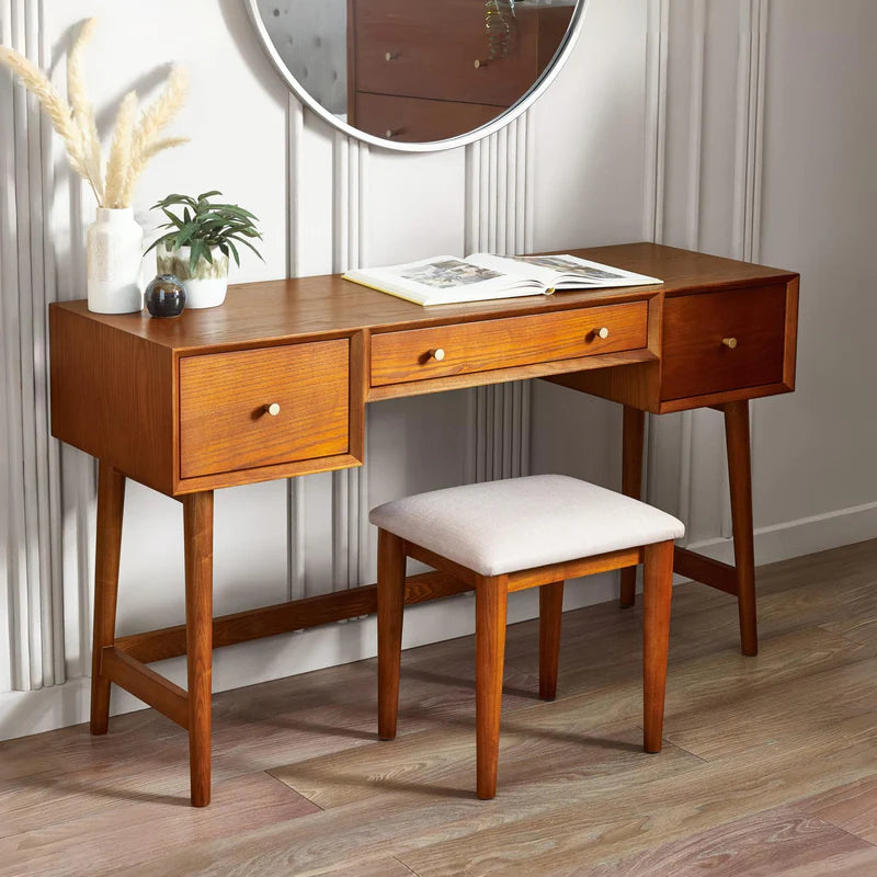 Wooden desk with three drawers and a matching stool on a white background