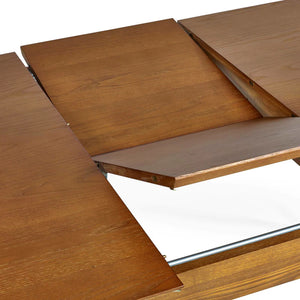 Wooden dining table with extended leaves on a white background