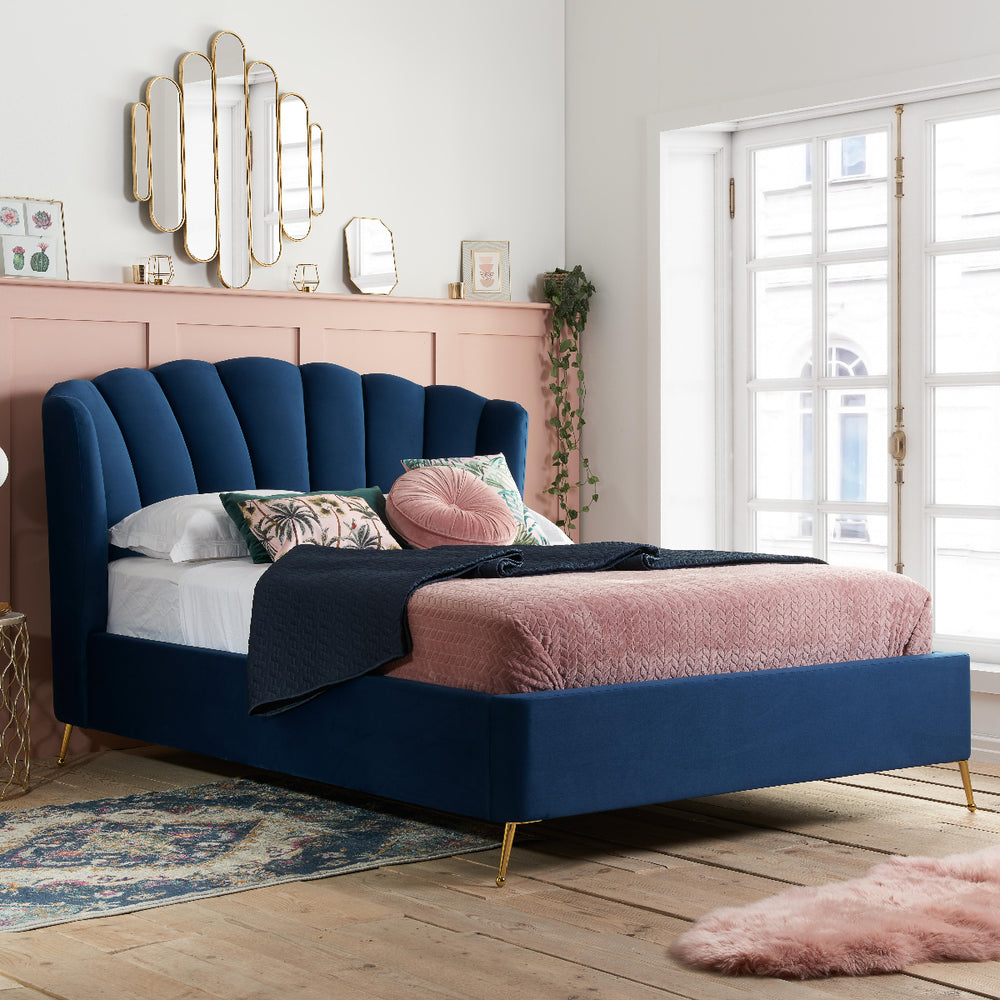 Navy blue bed with open storage compartment on a white background