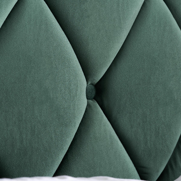 Close-up of a green tufted headboard