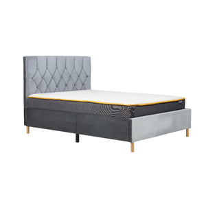 Gray upholstered bed with white mattress and yellow trim on a white background