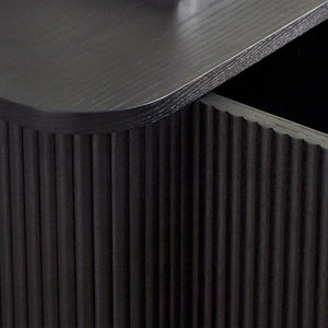 Dark wooden side table with textured surface and fluted detail