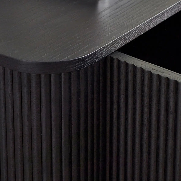 Dark wooden side table with textured surface and fluted detail