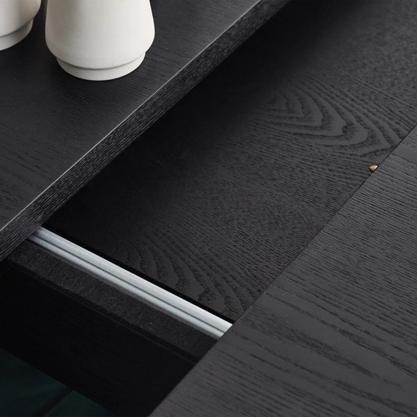 Close-up of a dark wooden surface with a white cylindrical object on top.