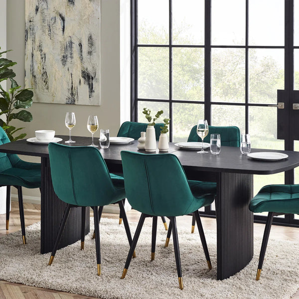 Dining room with a black table and teal chairs, set for a meal.