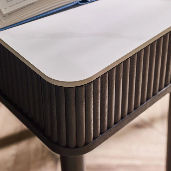 Modern side table with a white top and ribbed brown base