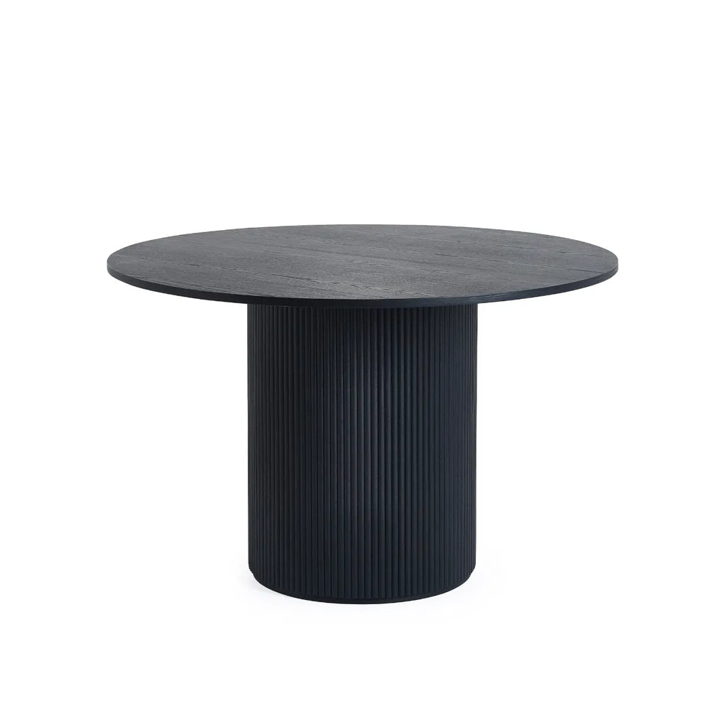 Round black table with ribbed cylindrical base on a white background
