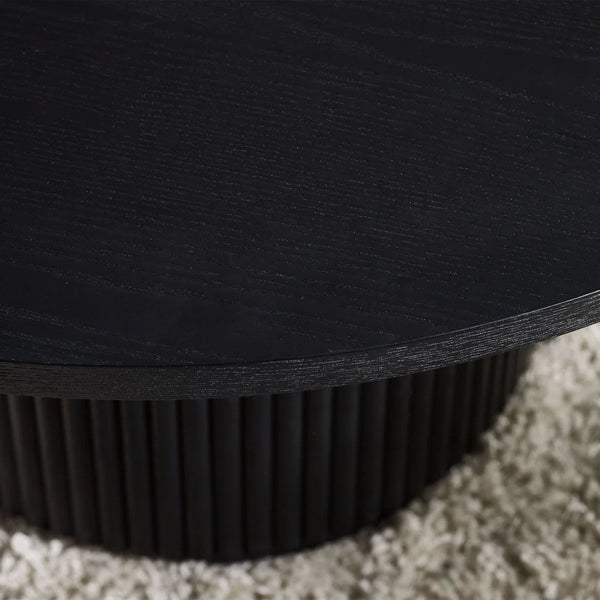 Close-up of a black round table on a carpeted floor