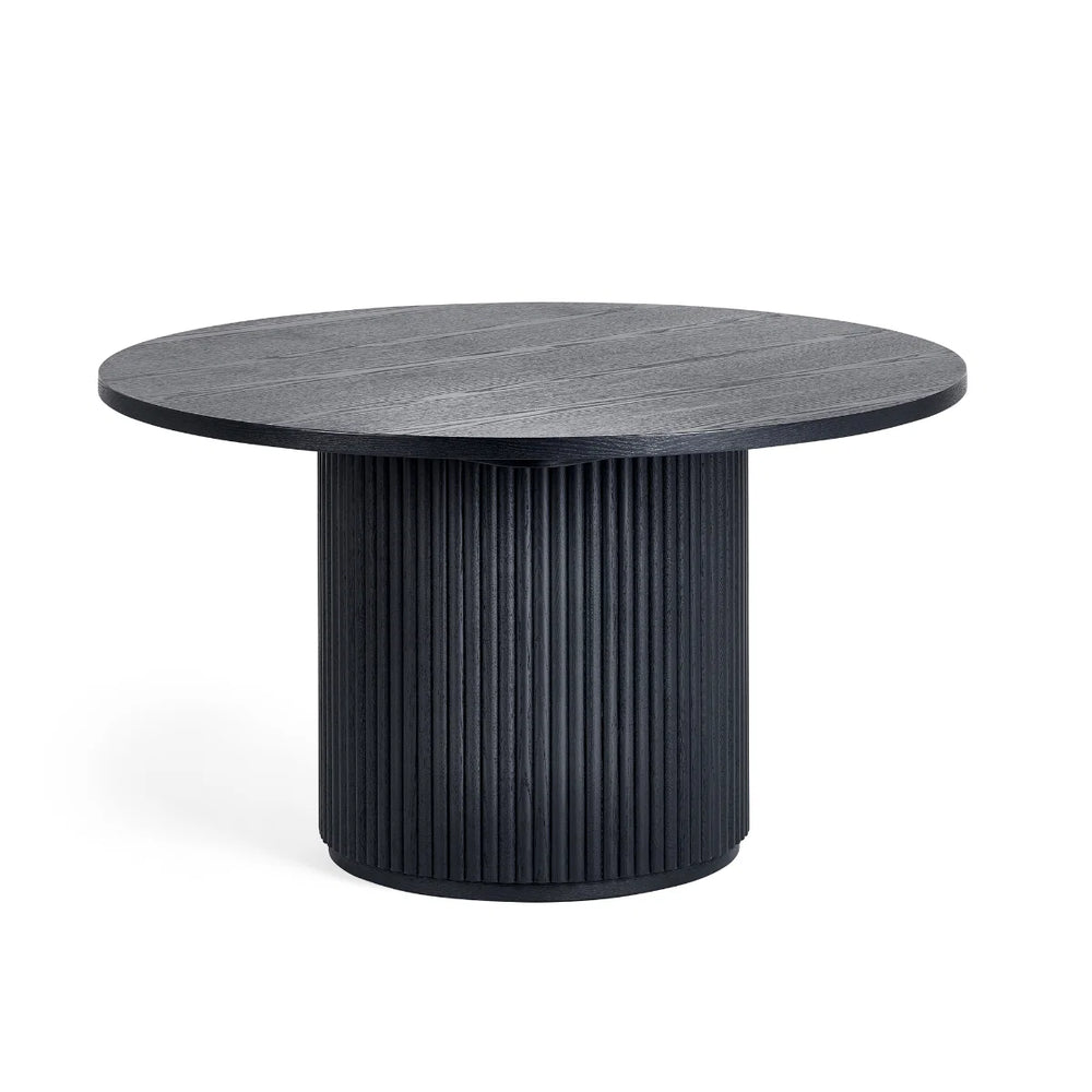 Round black table with ribbed cylindrical base on a white background