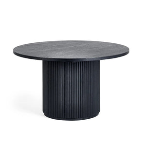 Round black table with ribbed cylindrical base on a white background